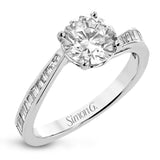 This engagement ring in 18 kt white gold has a gentle curved band of sparkling baguettes 0.39 ctw.