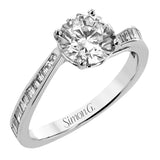 This engagement ring in 18 kt white gold has a gentle curved band of sparkling baguettes 0.39 ctw.