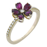 This delicate right hand ring has a flower design with petals of pear-shaped sapphires 1.06 ctw., with a diamond center and shank 0.13 ctw.