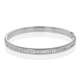 A striking 18K bangle in two-tone gold with a row of baguette diamonds 2.0 ctw. set in white gold, with a delicate ribbed edge