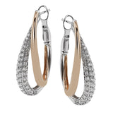 This stunning two-tone earring consists of a rose gold hoop interlocked with a white gold diamond encrusted hoop 0.87 ctw.
