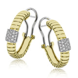 This elegant huggie earring in 18K yellow gold has a ribbed design and accented with 0.24 ctw. of pave set diamonds in white gold, and a lever back closure