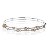 This whimsical bangle in 18K white gold features 1.80 ctw of bezel set diamonds, that appear to be suspended on a wire