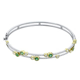 This whimsical bangle in 18K white gold features 1.80 ctw of bezel set diamonds, that appear to be suspended on a wire
