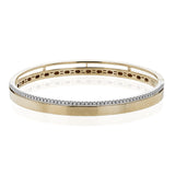 This stunning rose gold bangle has a matte finish and is accented by a row of white diamonds 0.32 ctw., along its edge.