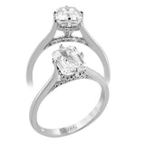 This elegant white gold engagement ring takes an Emerald center and is adorned with a delicate under halo, and a line of diamonds on the side profile 0.13 ctw