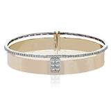 Stunning two-tone wide bangle in rose gold has a brushed finish and features a cluster of princess cut diamonds 0.43 ctw in its center, with a row of round brilliant diamonds 0.39 ctw. along the edge