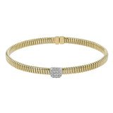 This modern design 18k yellow gold textured bangle with .19ctw diamonds set in a cushion shape and magnetic closure, is perfect for stacking
