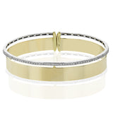Make a statement with this wide bangle in yellow gold with a brushed finish and accented by a row of white diamonds .40 ctw.