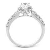 This 18K white gold antique design features a scalloped diamond halo which gives the ring a floral effect, and flush set side diamonds 0.48ctw, made for an oval center stone