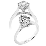 This elegant white gold engagement ring takes an oval center and is adorned with a delicate under halo, and a line of diamonds on the side profile 0.13 ctw