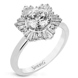 Crafted in 18K polished white gold, this distinctive ring features a halo of round diamonds 0.7 ctw, surrounded by a burst of baguette shaped diamonds 0.45 ctw.