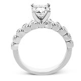 18K diamond engagement ring 0.90 ctw., features a half bezel setting on each individual side diamond which adds a modern bubble look to this ring