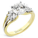 18 kt. floral inspired engagement ring has a yellow gold split shank and marquise side diamonds of .41 ctw set in white gold, along side the center stone creating the look of glimmering leaves