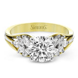 18 kt. floral inspired engagement ring has a yellow gold split shank and marquise side diamonds of .41 ctw set in white gold, along side the center stone creating the look of glimmering leaves