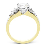 18 kt. floral inspired engagement ring has a yellow gold split shank and marquise side diamonds of .41 ctw set in white gold, along side the center stone creating the look of glimmering leaves