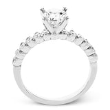 18K diamond engagement ring 0.50 ctw., features a half bezel setting on each individual side diamond which adds a modern bubble look to this ring