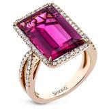 A modern marvel.  This 18k rose gold ring features 8.10ct rubelite surrounded by .58cttw diamonds.