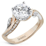 This unique two-tone engagement ring has a sculpted look and accent diamonds 0.21 ctw set to look like petals and dew drops, flanking the center stone