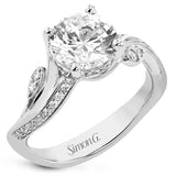 This unique two-tone engagement ring has a sculpted look and accent diamonds 0.21 ctw set to look like petals and dew drops, flanking the center stone