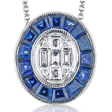 This art deco design oval pendant features fancy cut baguette sapphires 0.84 ctw., and diamond baguettes 0.16ctw. on a white gold chain