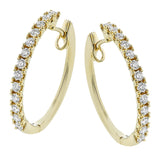 These beautiful diamond hoops are set in yellow gold, and have a prong set design with .70 ctw of diamonds