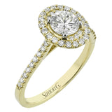 This diamond engagement ring has a sparkling line of prong set diamonds along the band, leading up to the center halo of round diamonds 0.39 ctw., and has 2 peek-a-boo yellow diamonds 0.02 ctw.