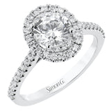 This diamond engagement ring has a sparkling line of prong set diamonds along the band, leading up to the center halo of round diamonds 0.39 ctw., and has 2 peek-a-boo yellow diamonds 0.02 ctw.