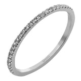 This diamond engagement ring has a sparkling line of prong set diamonds along the band, leading up to the center halo of round diamonds 0.39 ctw., and has 2 peek-a-boo yellow diamonds 0.02 ctw.
