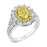 This very special ring is custom crafted for a 1.34 ct oval yellow diamond at the center. This stone is then surrounded by an inner halo of round yellow diamonds and a larger outer halo of princess cut white diamonds.