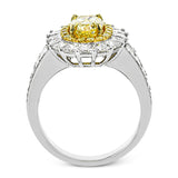 This very special ring is custom crafted for a 1.34 ct oval yellow diamond at the center. This stone is then surrounded by an inner halo of round yellow diamonds and a larger outer halo of princess cut white diamonds.