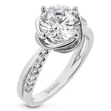 This criss-cross design engagement ring shimmers with 0.15 ctw round diamonds and a halo of gold strands wrapped around the center