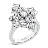 This incredible 18k white gold ring certainly makes a statement with diamonds in round, baguette, asscher, and pear shapes all combined in a geometric setting.