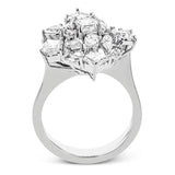 This incredible 18k white gold ring certainly makes a statement with diamonds in round, baguette, asscher, and pear shapes all combined in a geometric setting.