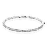 This modern white gold bangle has a distinctive twisting design set with 1.68 ctw of white diamonds.