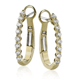 Day to night, the perfect transitional earring, these oval hoops are available in 18K white, yellow and rose gold and feature .32cttw round white diamonds.