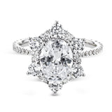 Like a crystallized explosion of light, this remarkable engagement ring design features a supernova of .60 ctw of diamonds surrounding the oval shaped center stone, as well as .38 ctw of smaller diamonds down the band.