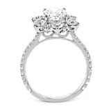 Like a crystallized explosion of light, this remarkable engagement ring design features a supernova of .60 ctw of diamonds surrounding the oval shaped center stone, as well as .38 ctw of smaller diamonds down the band.