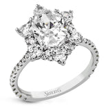 Like a crystallized explosion of light, this remarkable engagement ring design features a supernova of .60 ctw of diamonds surrounding the oval shaped center stone, as well as .38 ctw of smaller diamonds down the band.