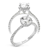 Part of our Underhalo Collection, this engagement ring contains the perfect touch of white diamonds that wink from underneath the center stone setting as well as down the sides of the ring.