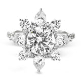 Pear shaped diamonds are set into a pointed halo that expands outward like a cosmic explosion in this Supernova Collection engagement ring.