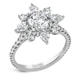 Pear shaped diamonds are set into a pointed halo that expands outward like a cosmic explosion in this Supernova Collection engagement ring.