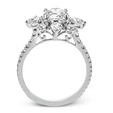 Pear shaped diamonds are set into a pointed halo that expands outward like a cosmic explosion in this Supernova Collection engagement ring.