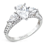 Pear shaped side stone set horizontally give this 18k white gold engagement ring a modern feel, accentuating the pear shape center stone.
