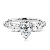 Pear shaped side stone set horizontally give this 18k white gold engagement ring a modern feel, accentuating the pear shape center stone.