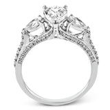 Pear shaped side stone set horizontally give this 18k white gold engagement ring a modern feel, accentuating the pear shape center stone.