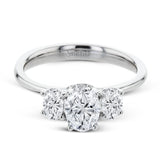 This 18k white gold engagement ring is a updated take on a classic three stone design, this time rendered with three sparkling oval shaped diamonds.