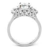 This remarkable engagement ring is our take on a classic three stone, with an intricate side design and 1.00 ctw side diamonds.
