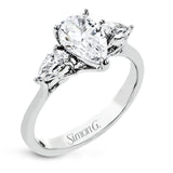 This distinctive three stone ring is new take on a classic style, with .45 ctw of pear shaped side diamonds highlighting the pear shaped center stone.