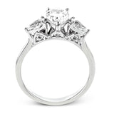 This distinctive three stone ring is new take on a classic style, with .45 ctw of pear shaped side diamonds highlighting the pear shaped center stone.